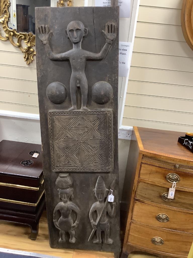 An African carved hardwood panel, width 42cm height 176cm